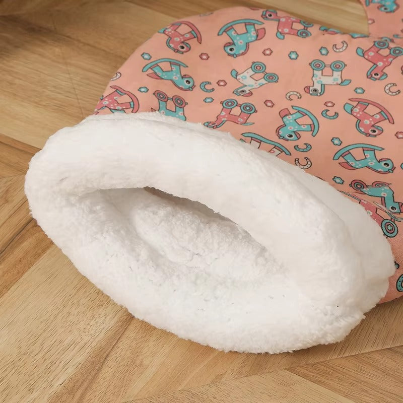 Pink patterned cat sleeping bag with a cream-colored opening