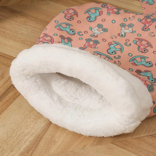Pink patterned cat sleeping bag with a cream-colored opening